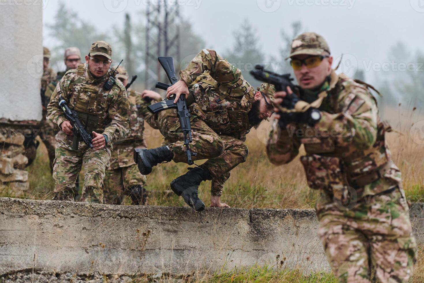 A highly trained elite military unit, clad in camouflage, skillfully navigates through perilous forest terrain, overcoming obstacles and executing a precise and covert mission photo