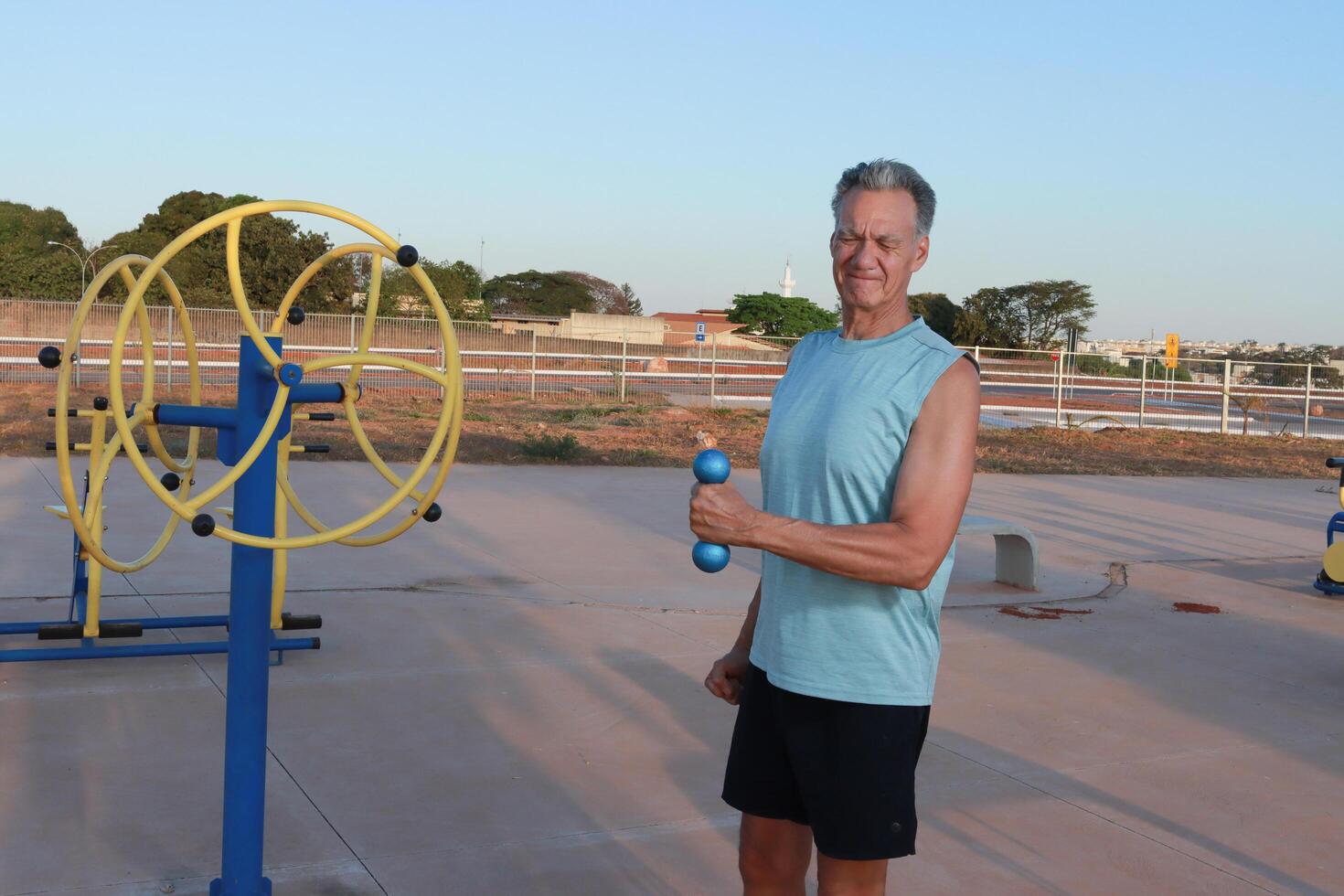 Older Man doing External Shoulder Rotation exercise with light weights for should pain photo