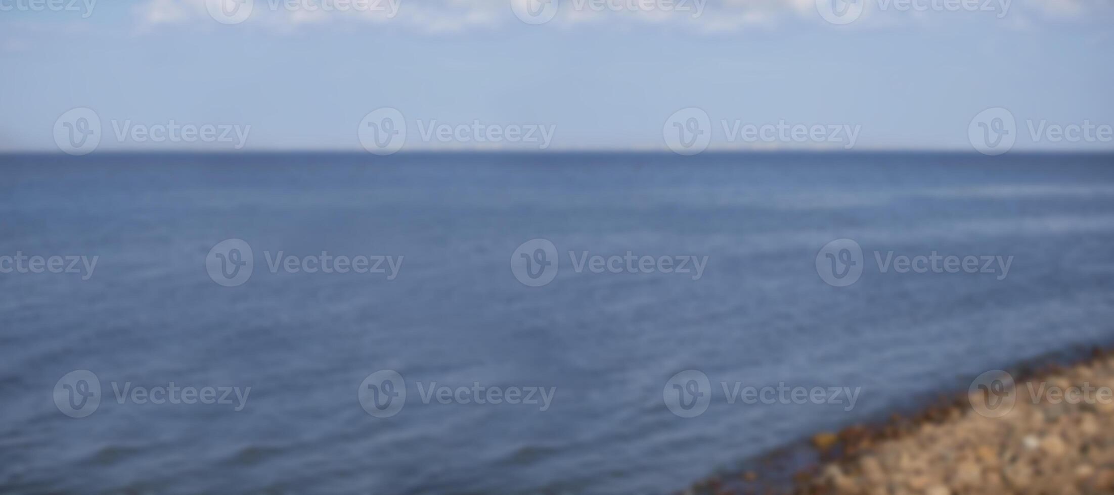 Banner blurred water stones and sky. Background water landscape in defocus. photo