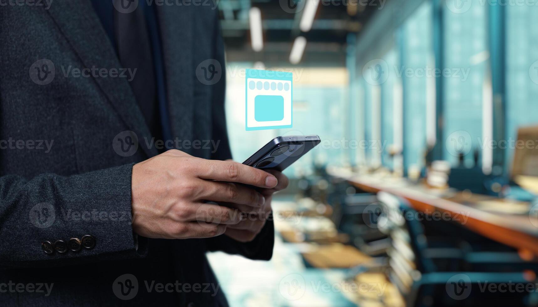 A man in a suit holding a smartphone with a chip on it photo