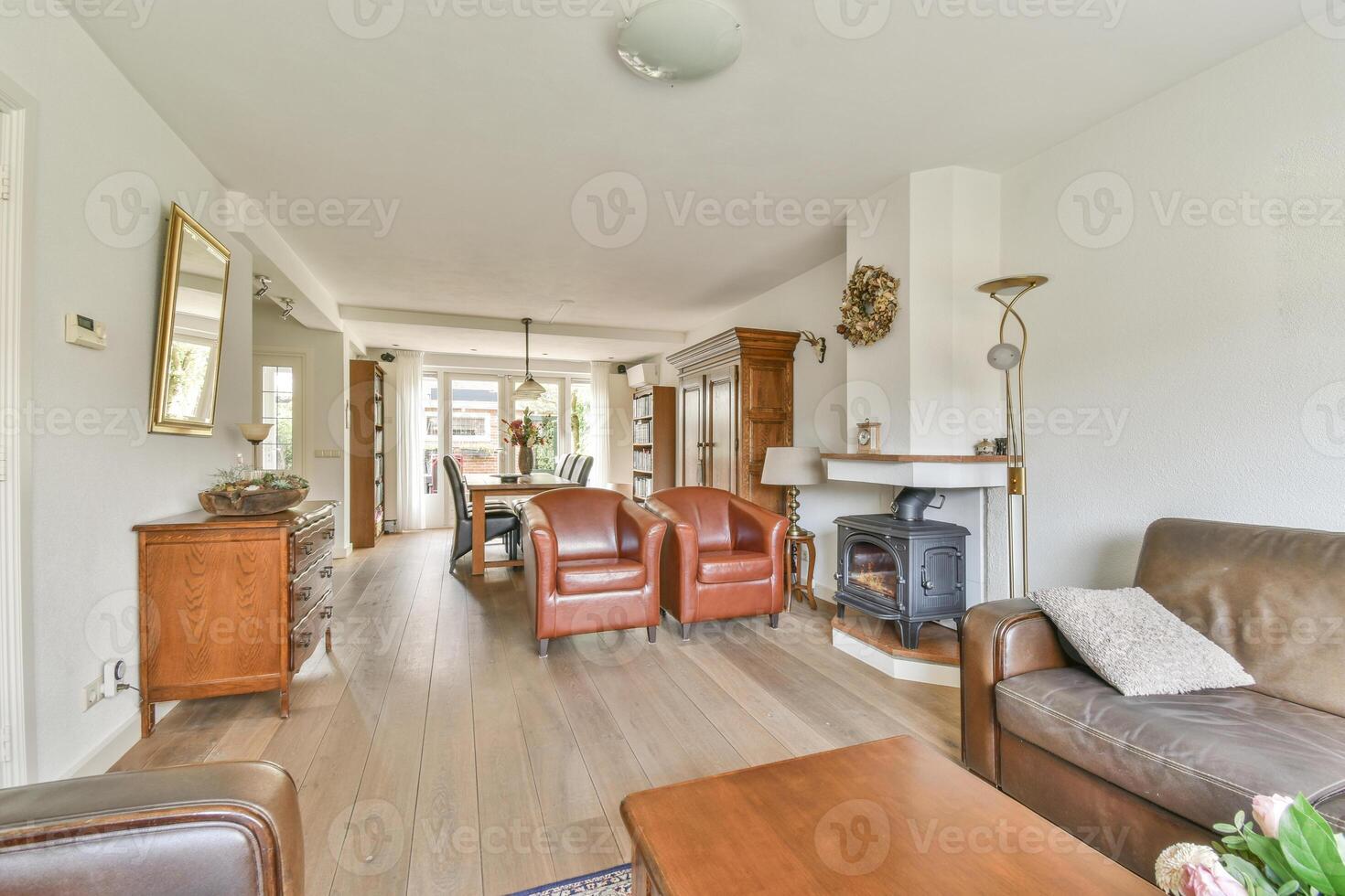A living room with a couch, chair and table photo