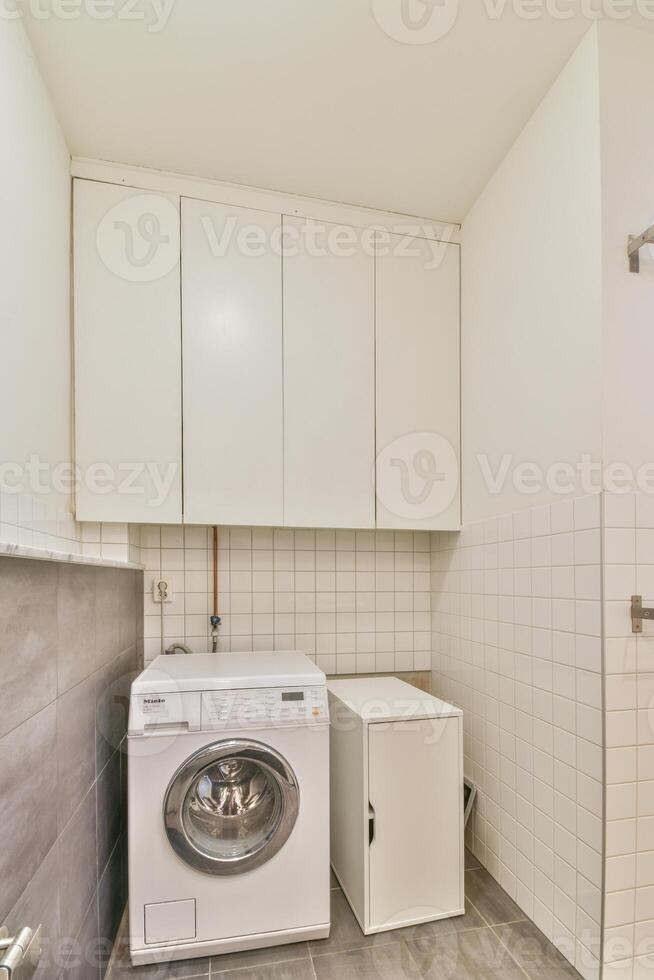 A white washer and dryer in a small laundry room photo