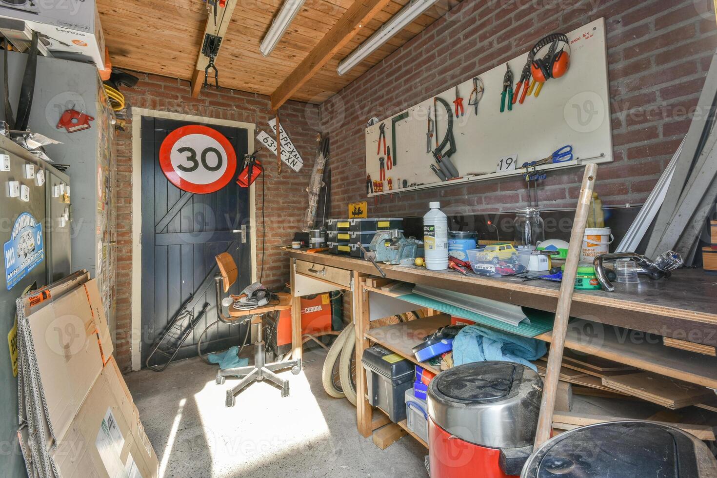 A garage with tools and a sign on the wall photo