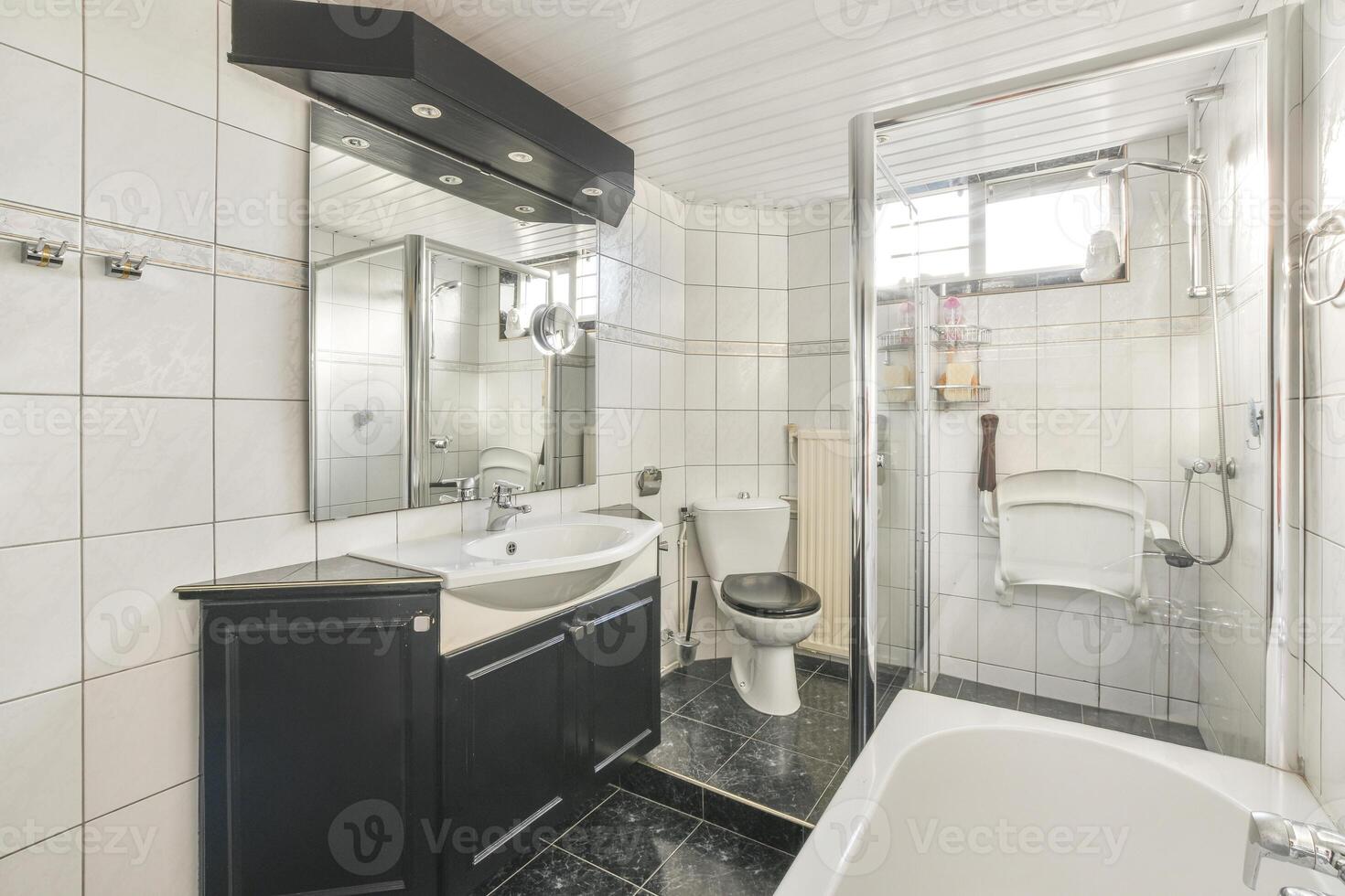 A bathroom with a sink, toilet, and shower photo
