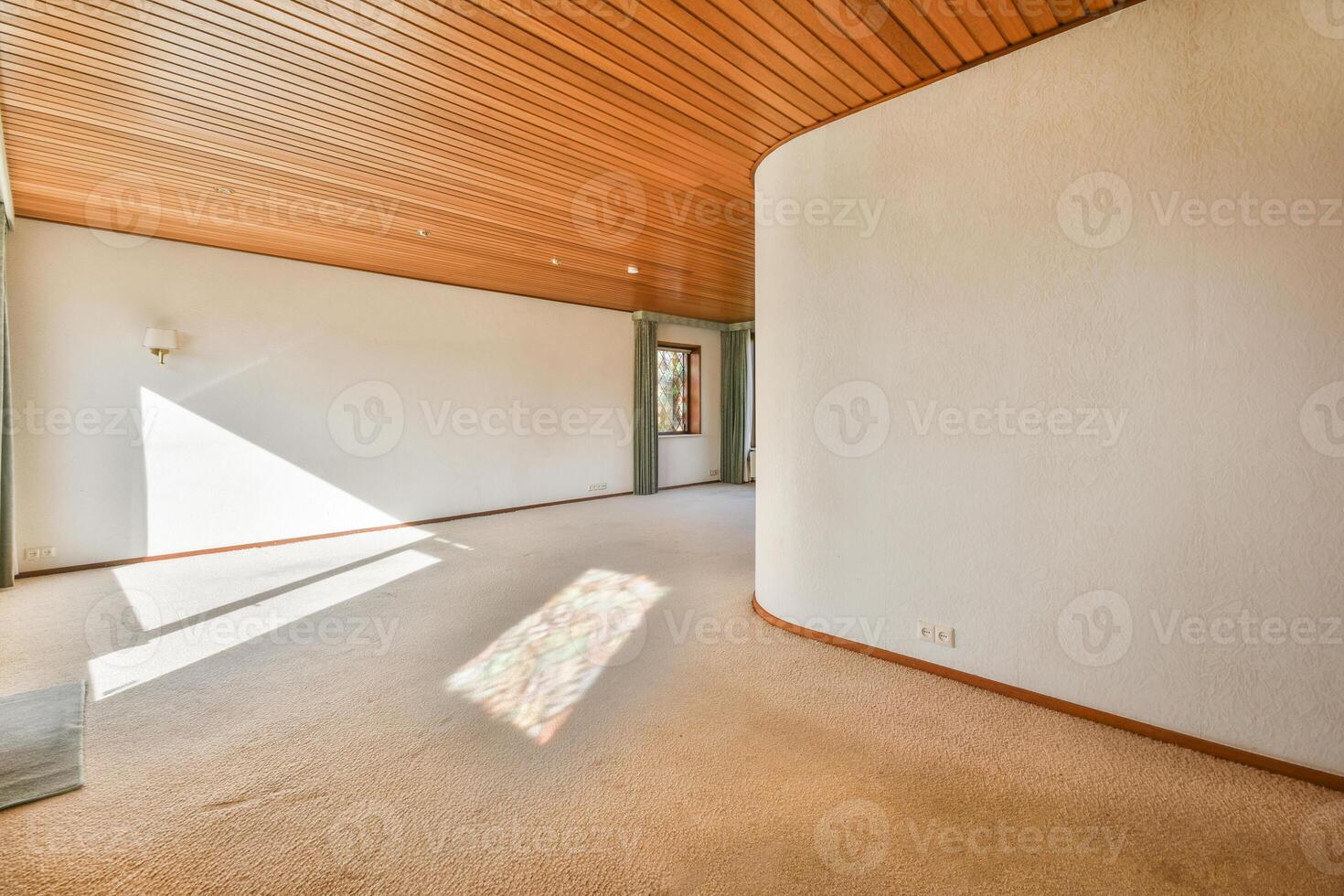 A room with a wooden ceiling and carpeting photo