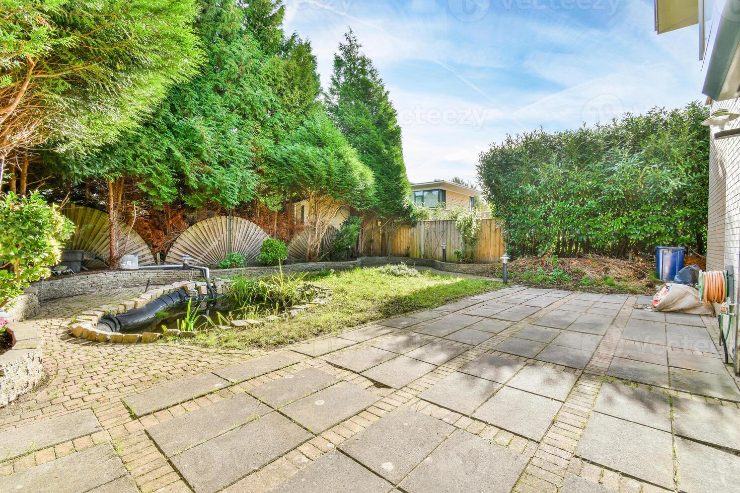 A backyard with a patio and a garden photo