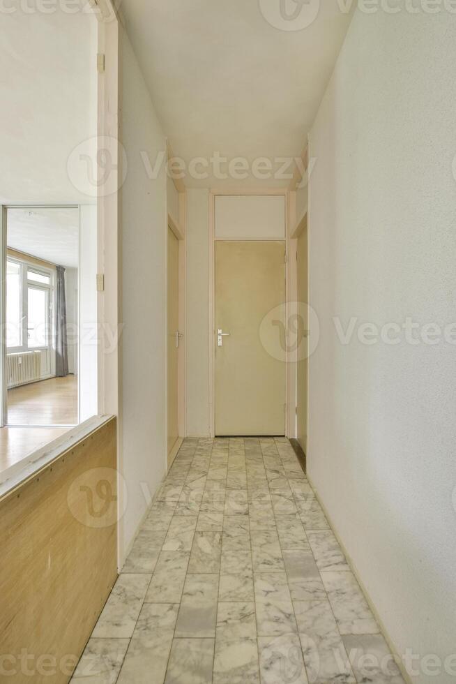A hallway with a door and a mirror photo