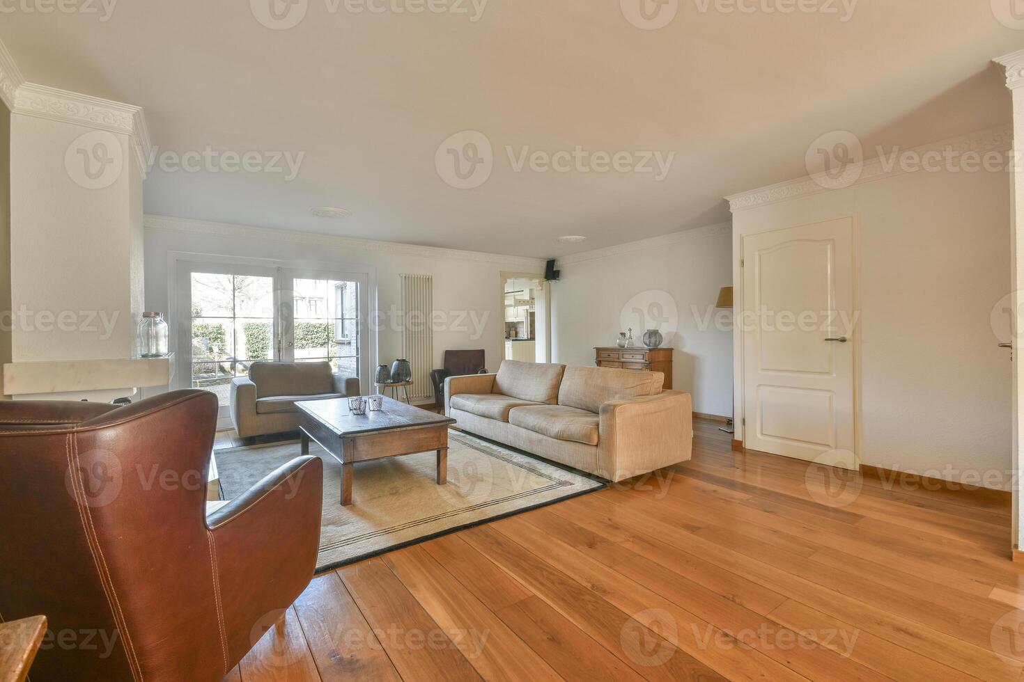 A living room with wooden floors and a couch photo