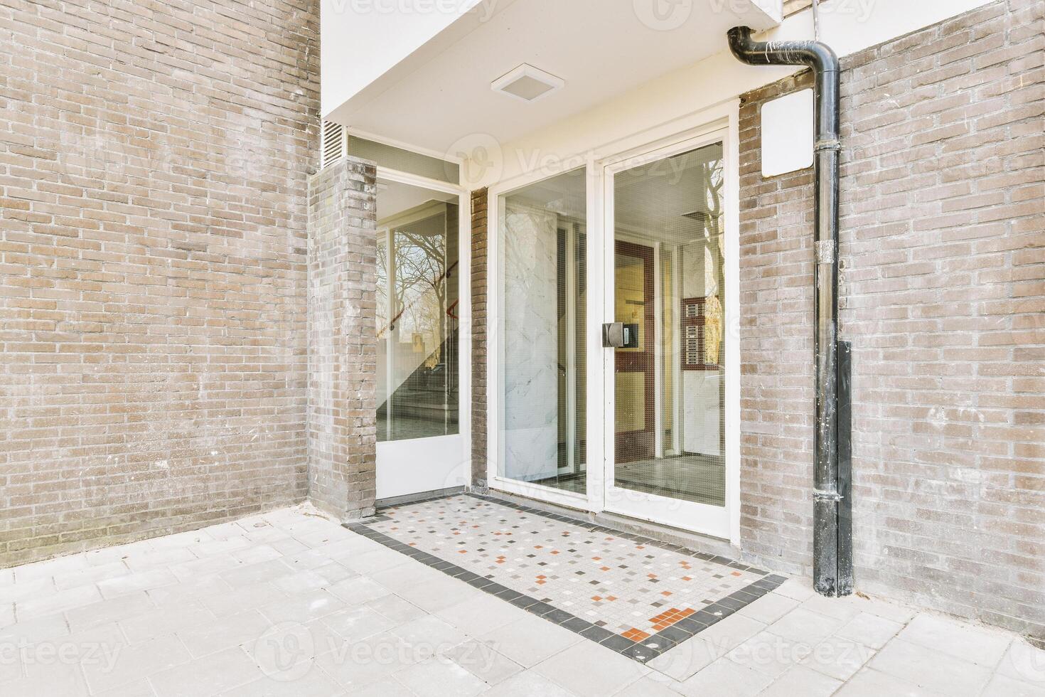 A brick building with a door and a window photo