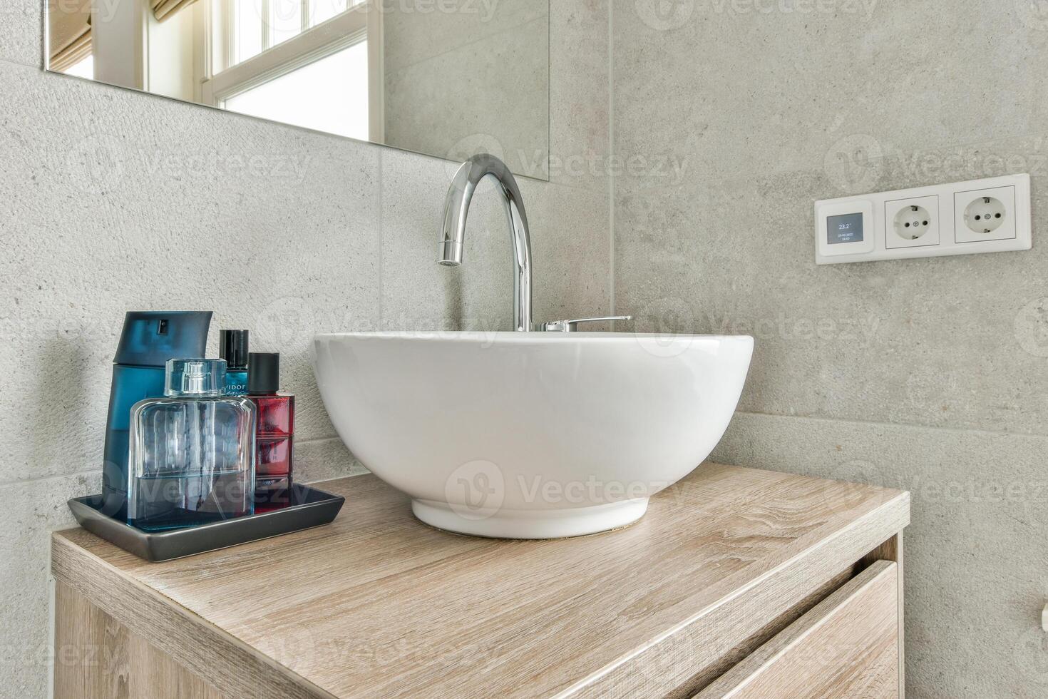 A bathroom sink with a white bowl and a mirror photo