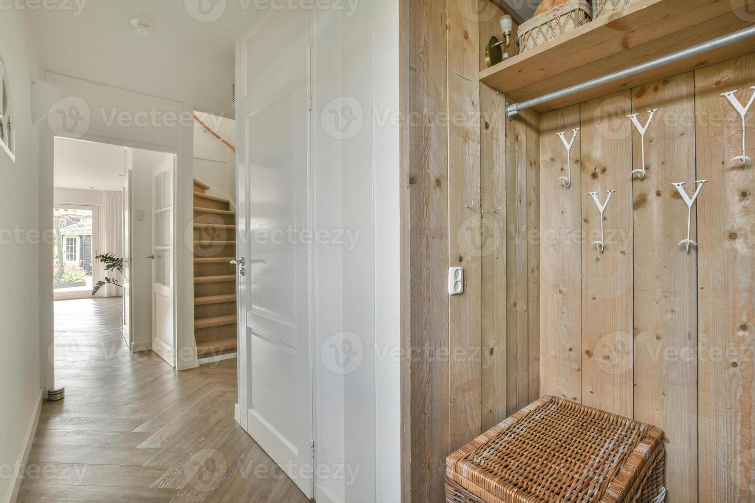 A hallway with wooden walls and a wooden bench photo