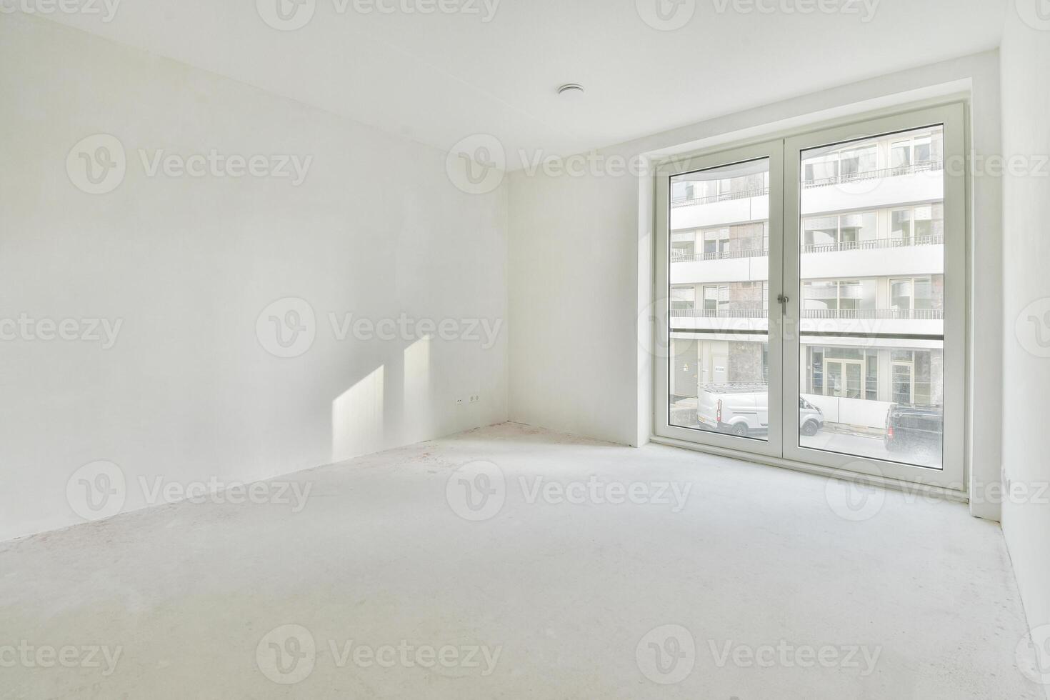 Empty room with white walls and large windows photo