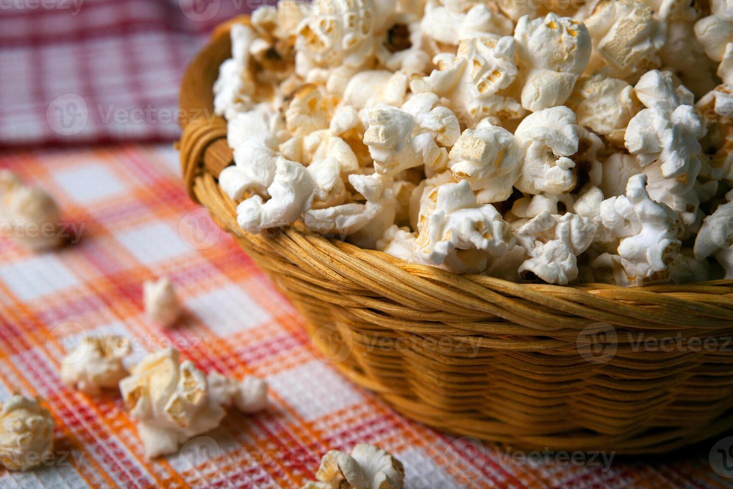 salted popcorn in a wicker basket on a napkin photo