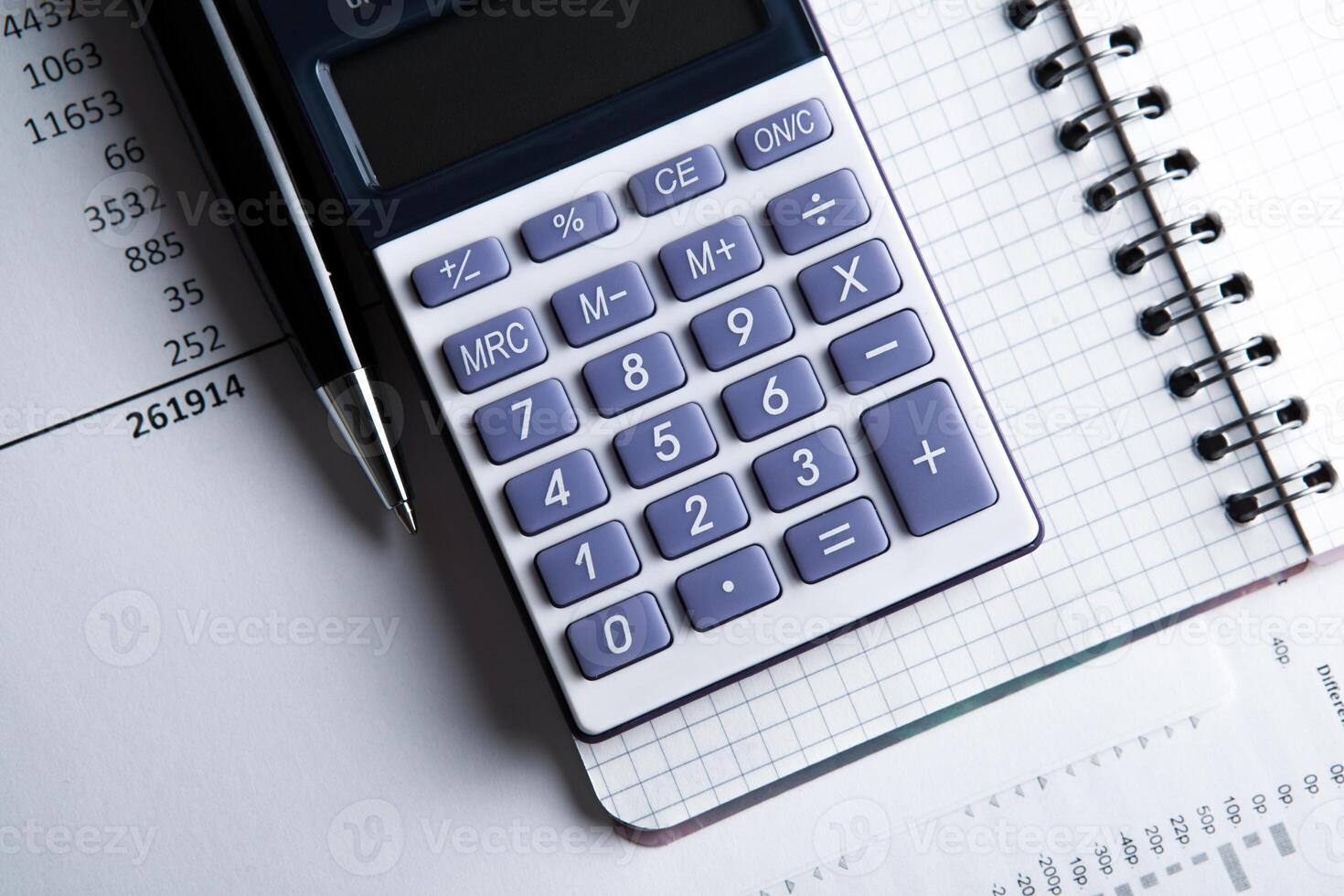 work on the calculator and papers photo