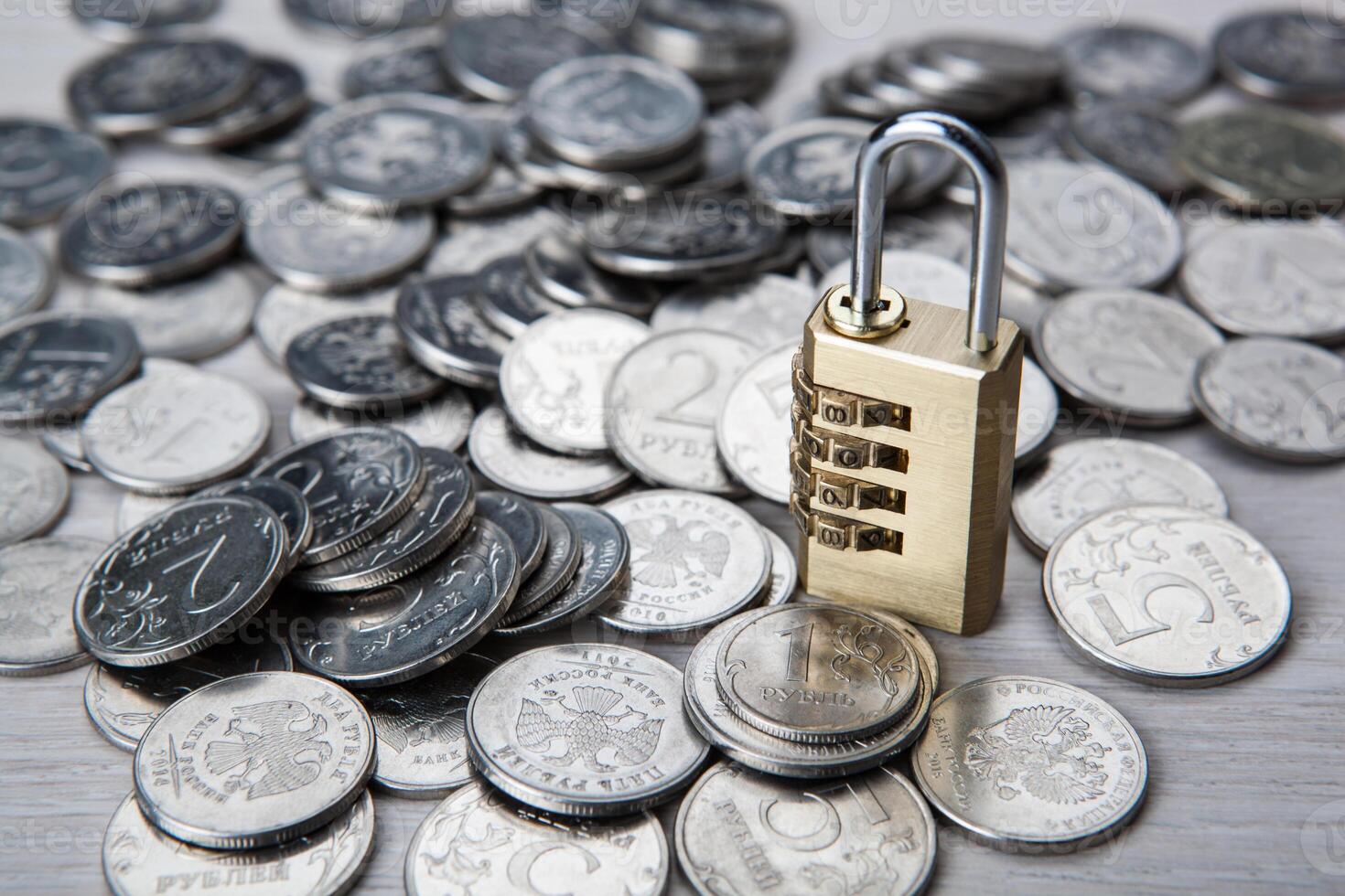 brass padlock with code and russian ruble coins photo