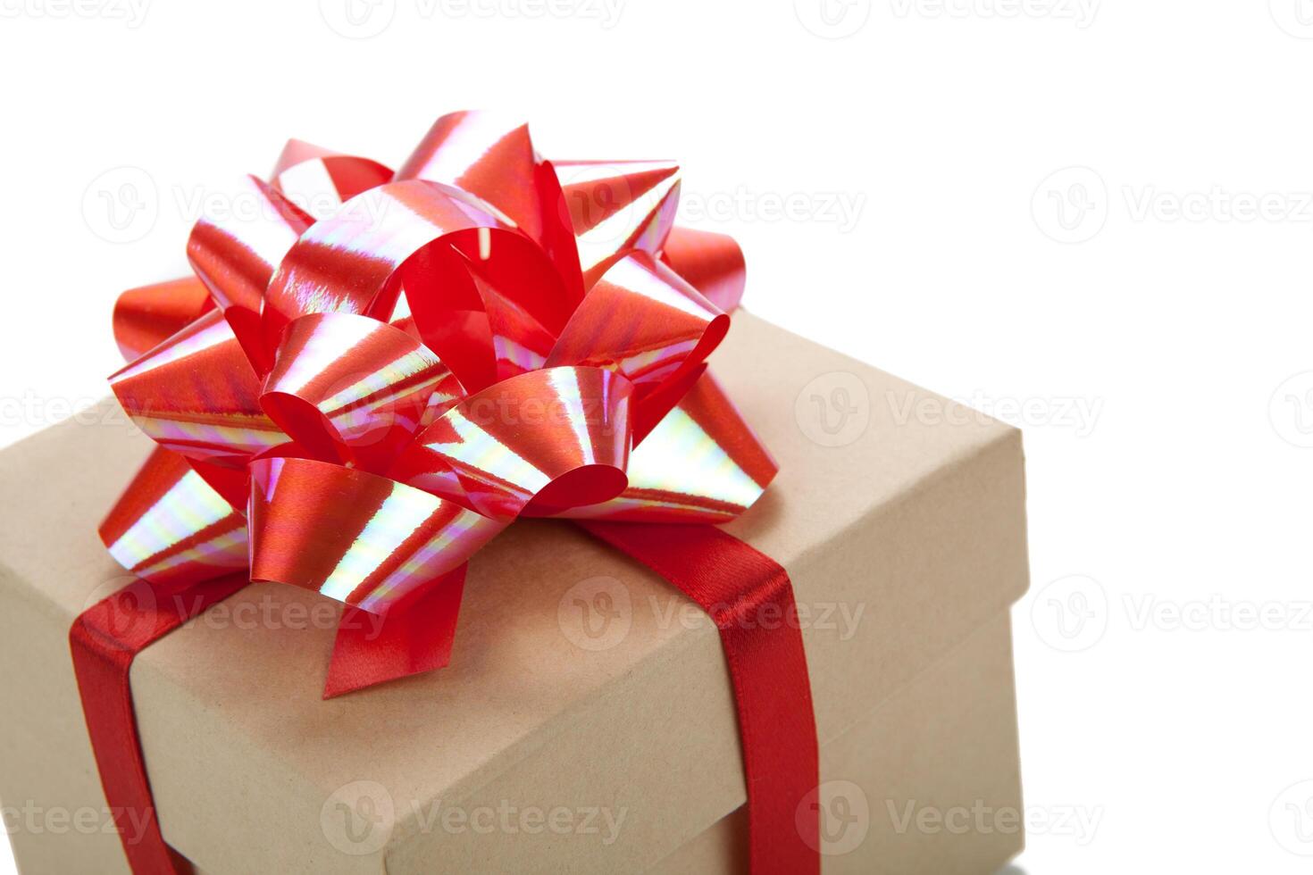 One festive gift box with a red bow on a white photo