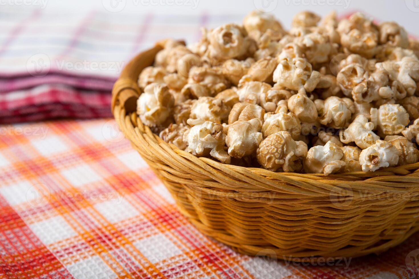 caramel popcorn in a basket on a napkin photo
