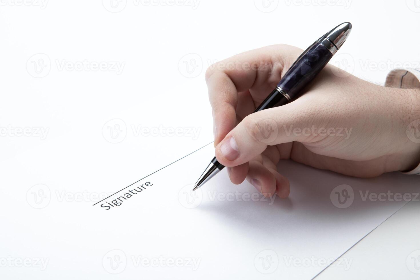 pen in the man's hand and signature photo
