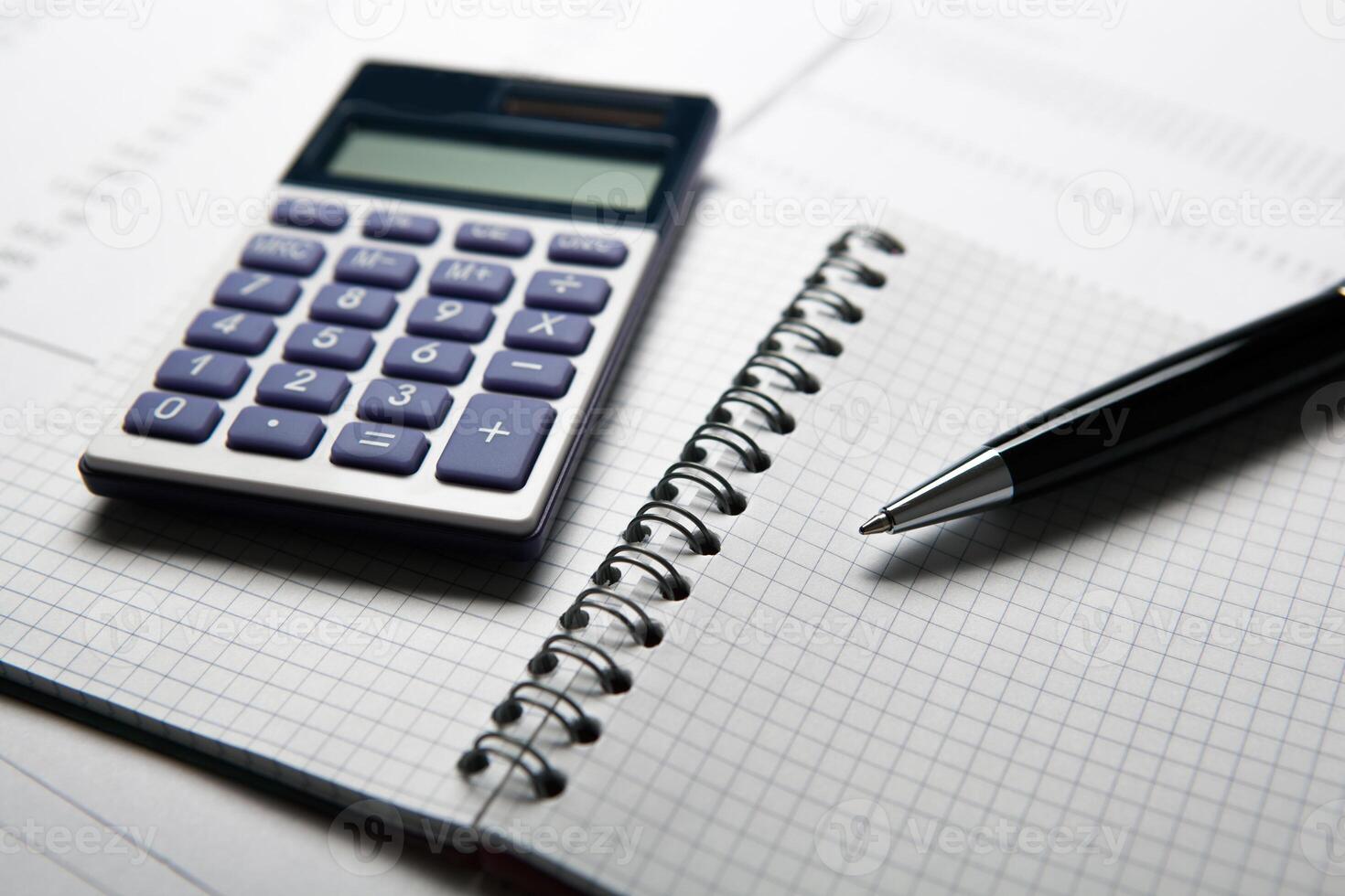 work on the calculator and papers photo