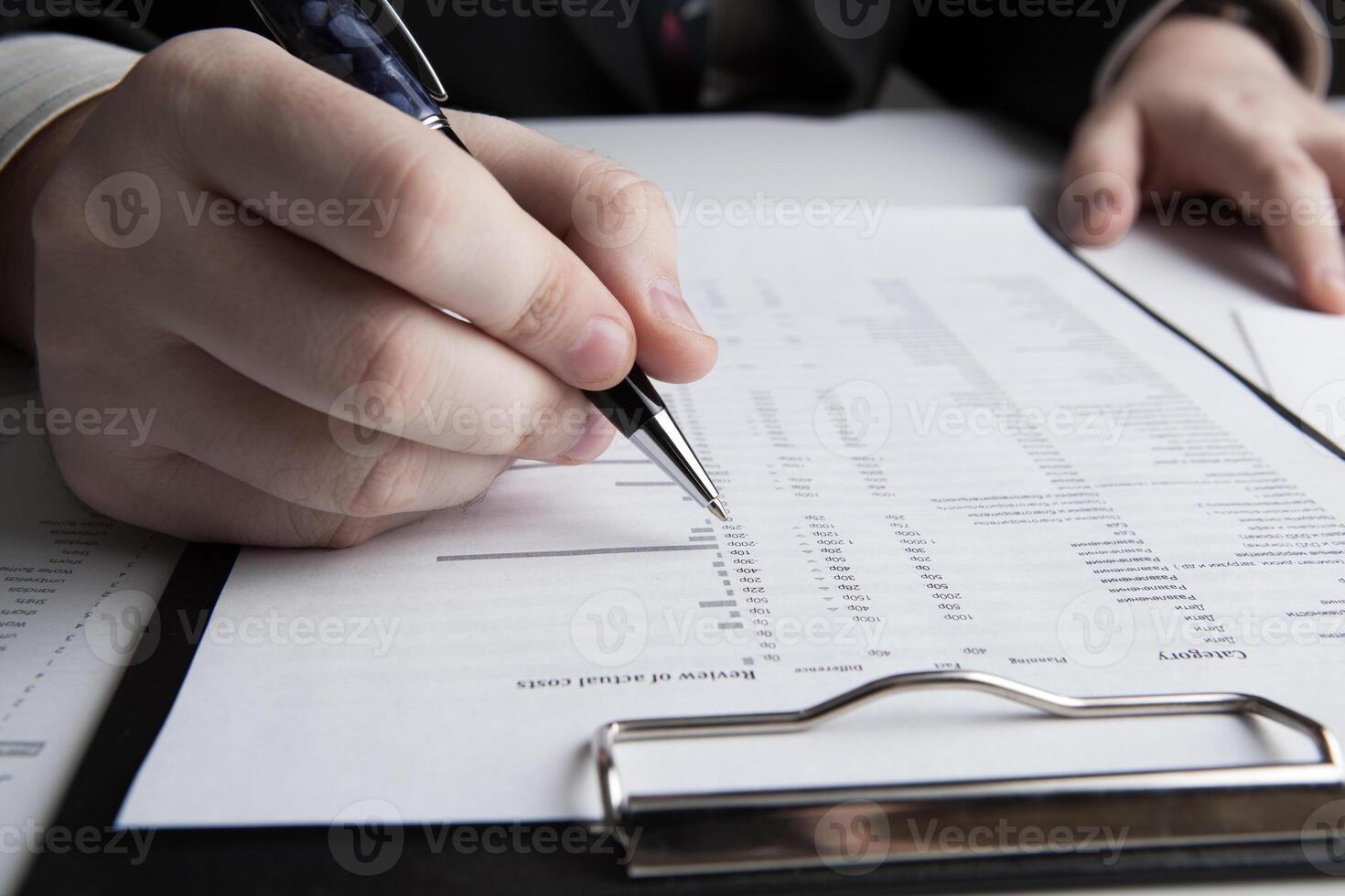 man is looking for information in the in the budget figures photo