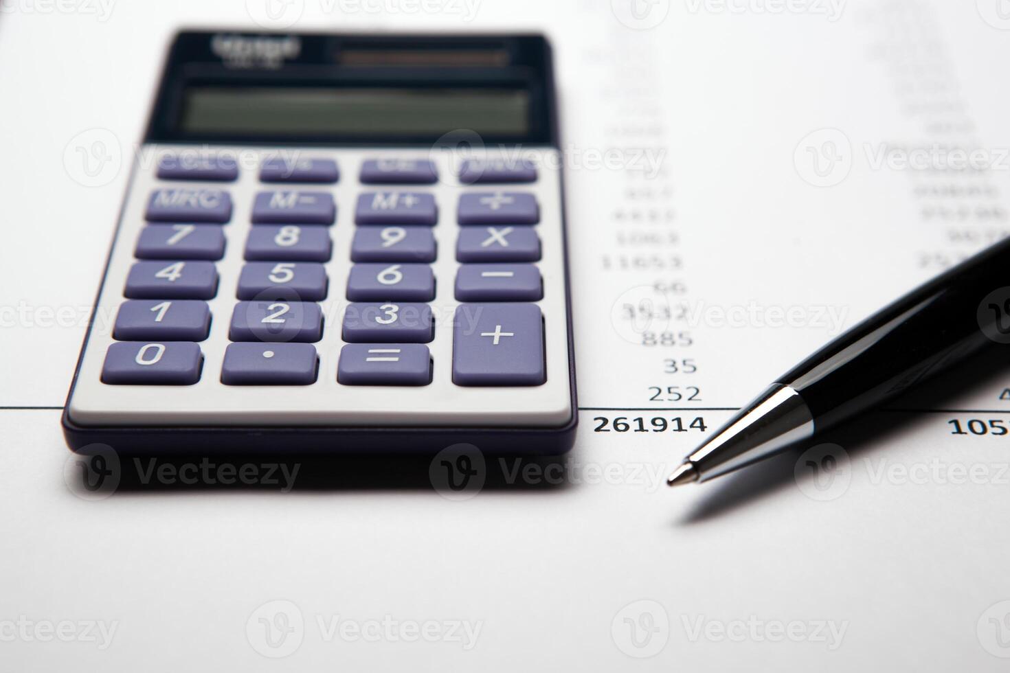 work on the calculator and papers photo