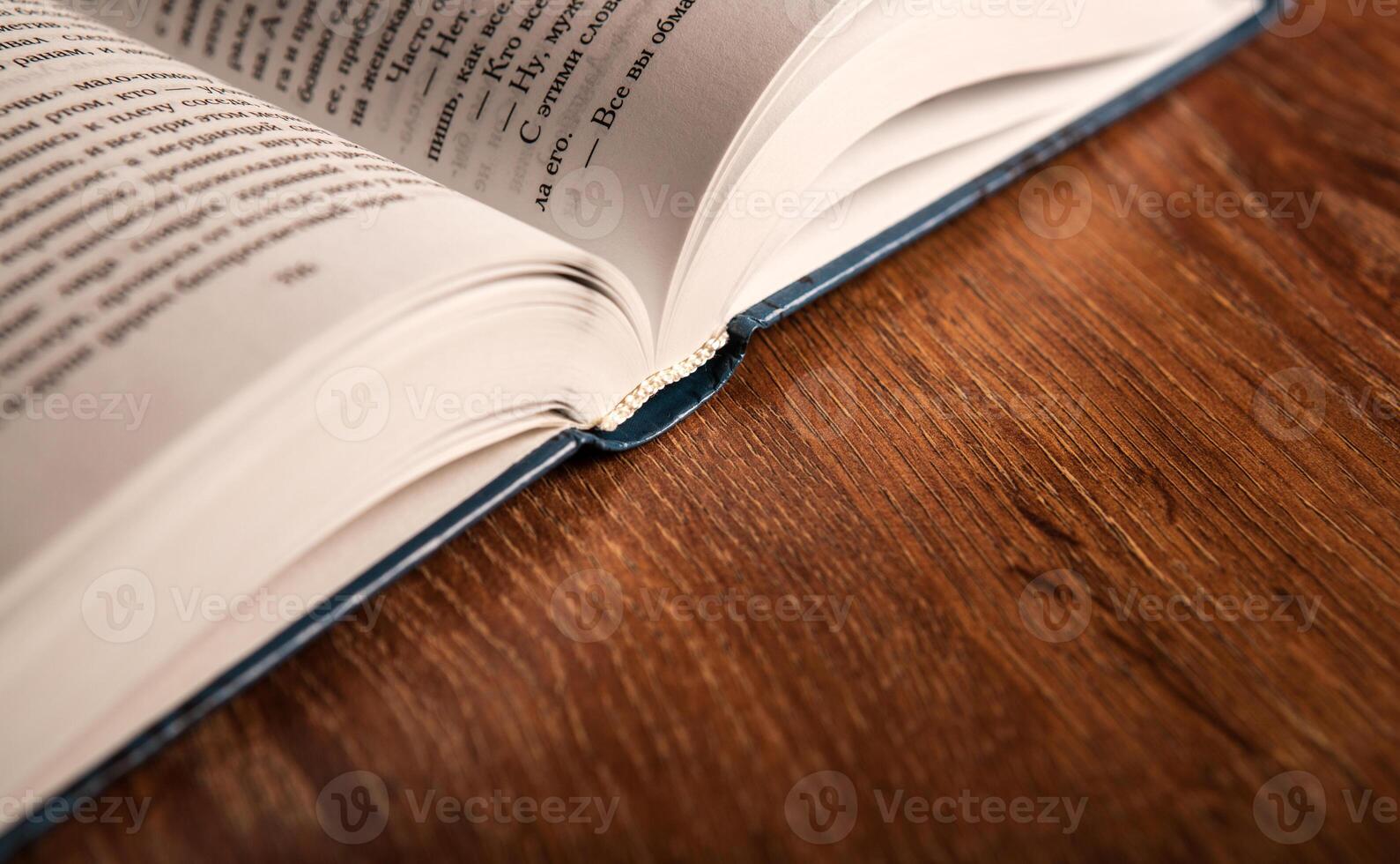 open large book on a wood table photo