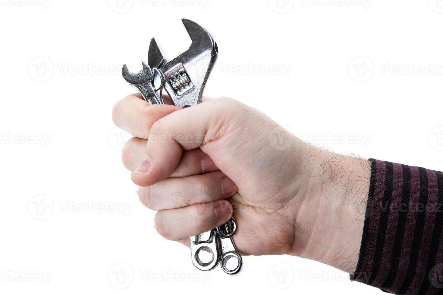 small slack wrenches and one adjustable wrench in hand isolated photo