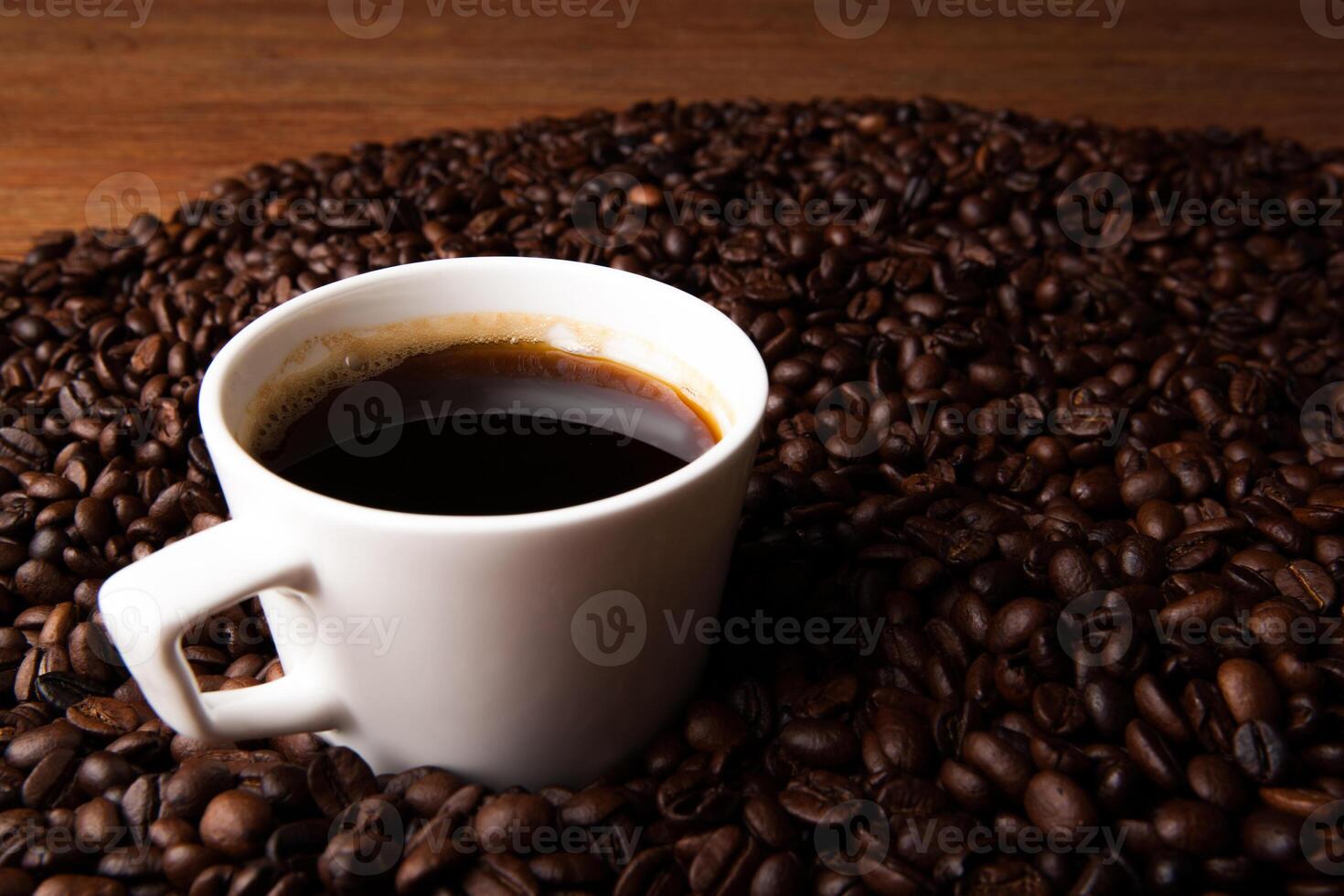 cup of black coffee with roasted coffe beans photo