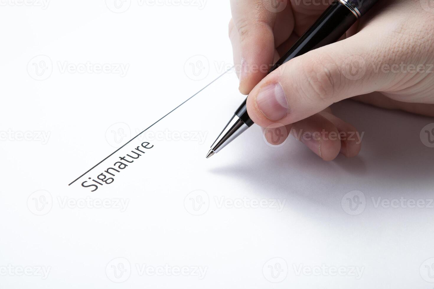 pen in the man's hand and signature photo
