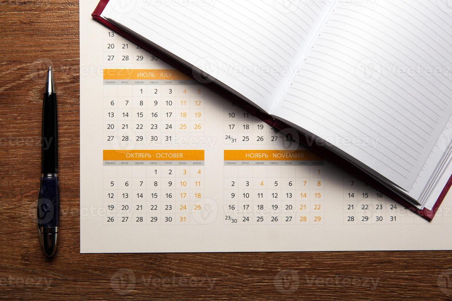 wall calendar with pen and diary closeup photo