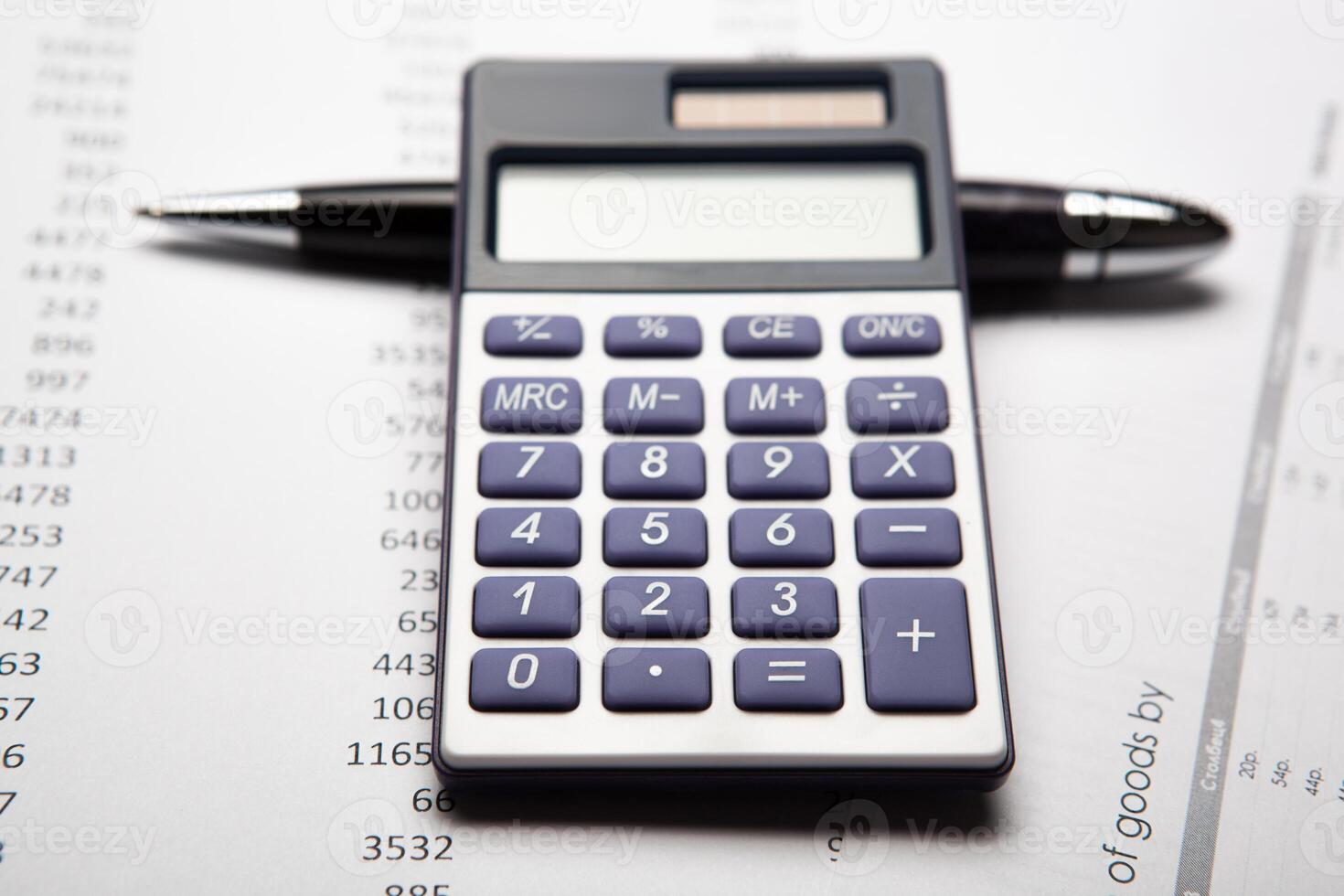 work on the calculator and papers photo