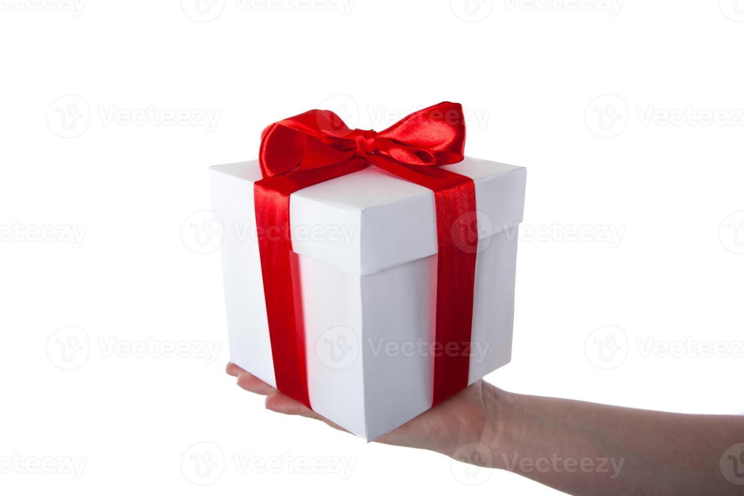 white gift box with red ribbon in hand photo