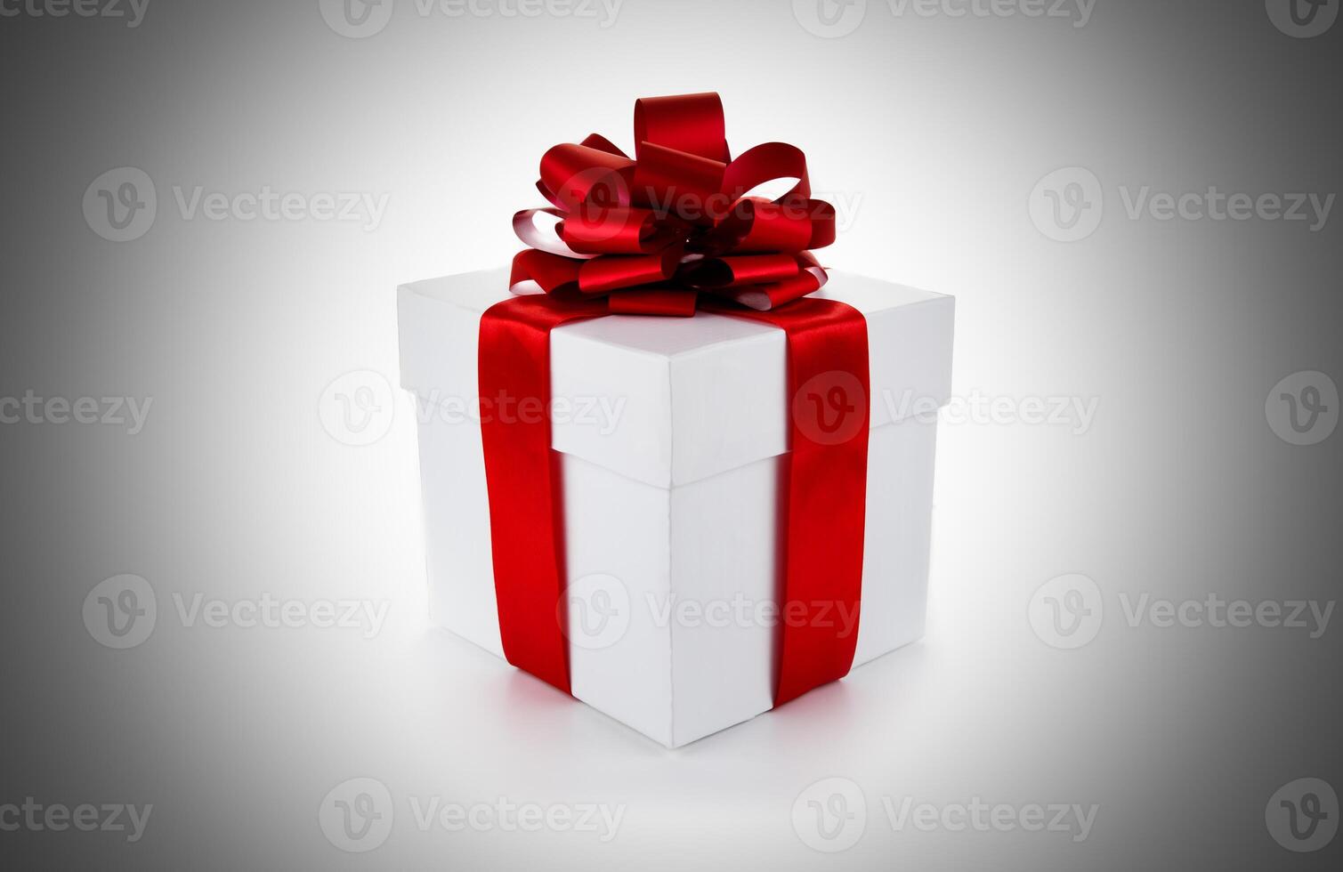 White gift box with red ribbon and bow photo