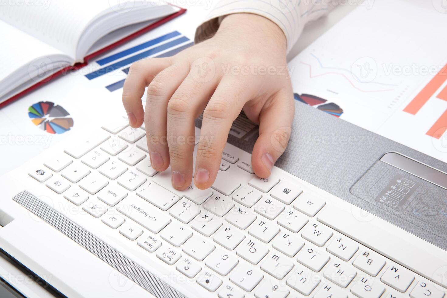 human hands on the notebook keyboard photo