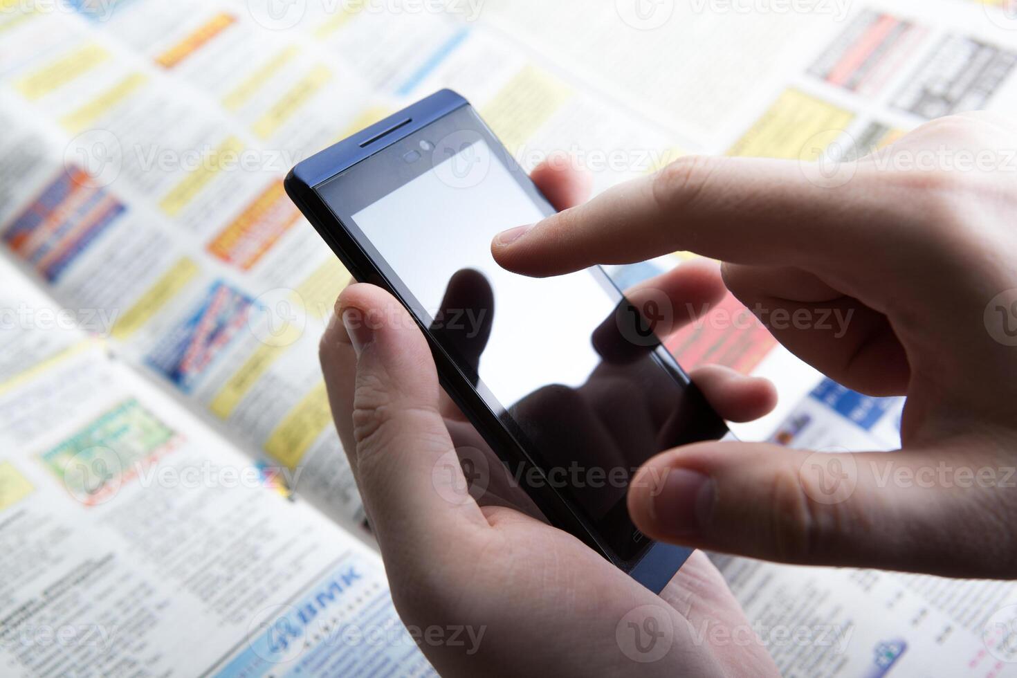 man working on a smartphone in office photo