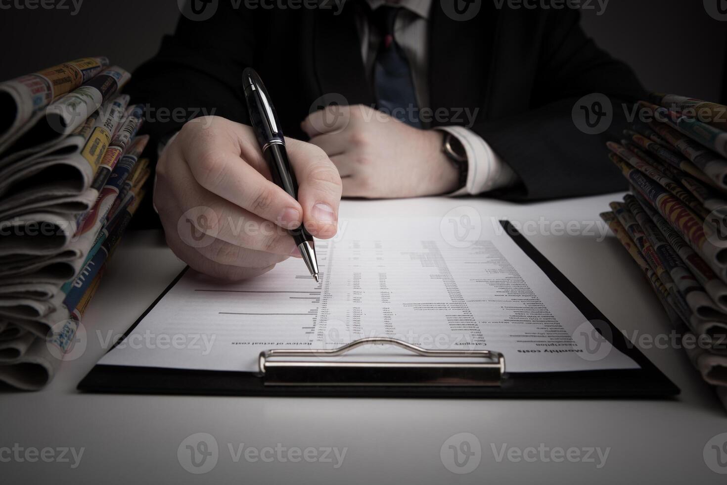 man is looking for information in the in the budget figures photo
