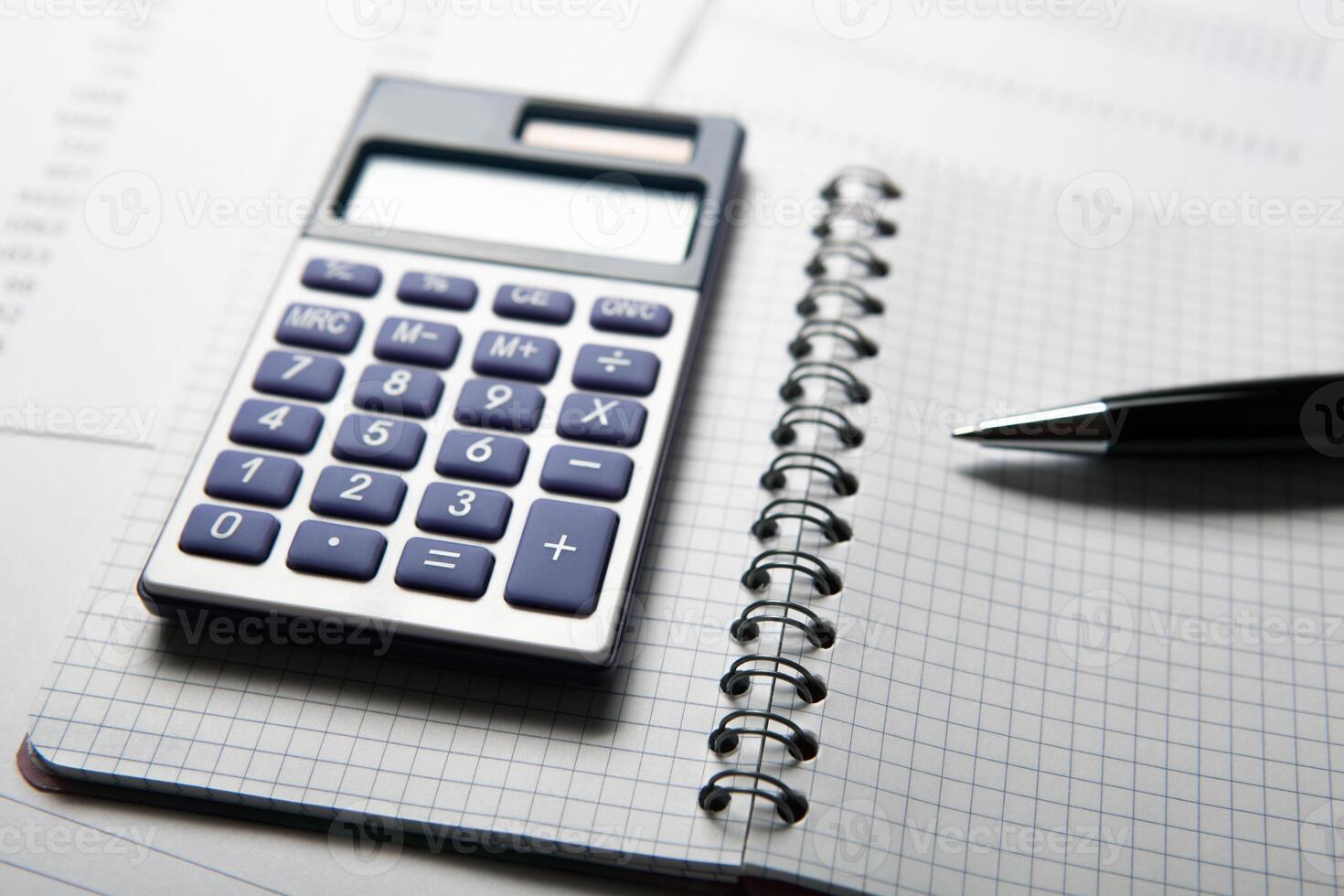 work on the calculator and papers photo