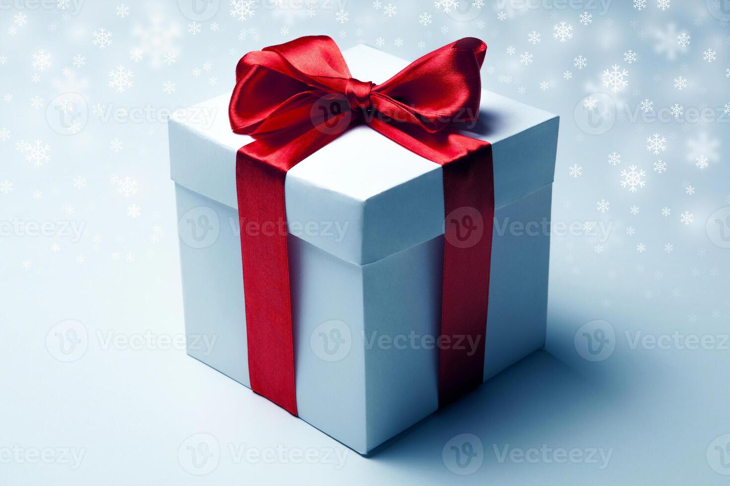 White gift box with red ribbon photo