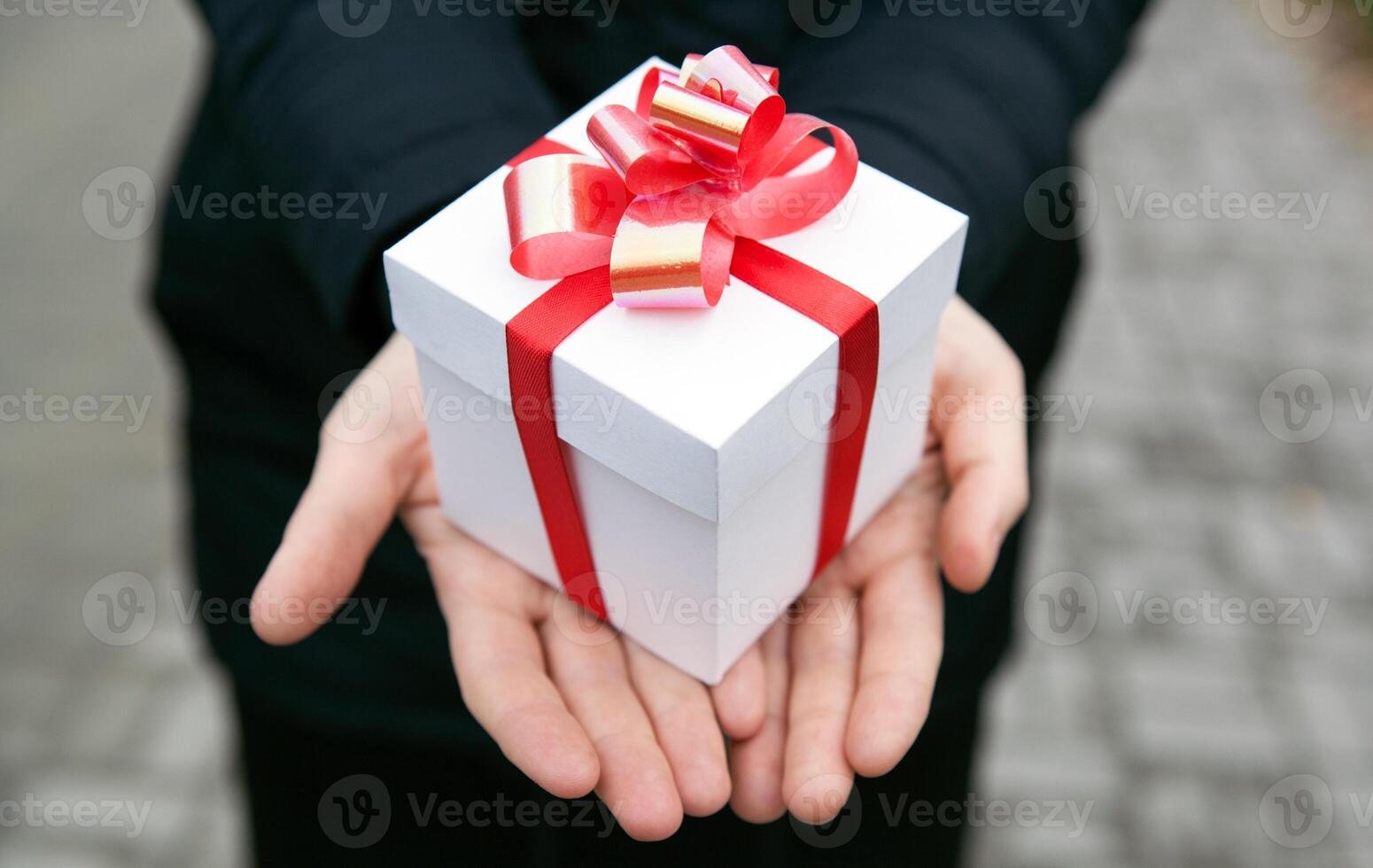 Female hands give you a gift box photo