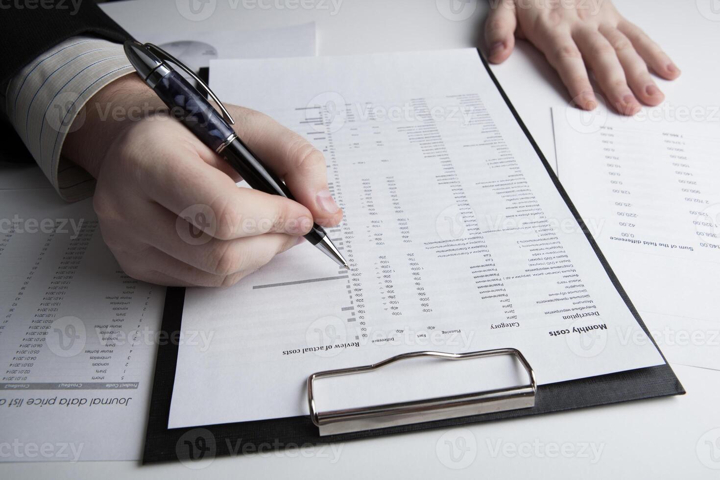 man is looking for information in the in the budget figures photo