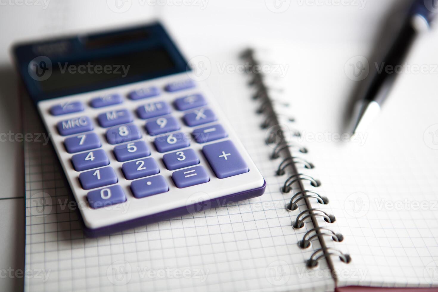 work on the calculator and papers photo