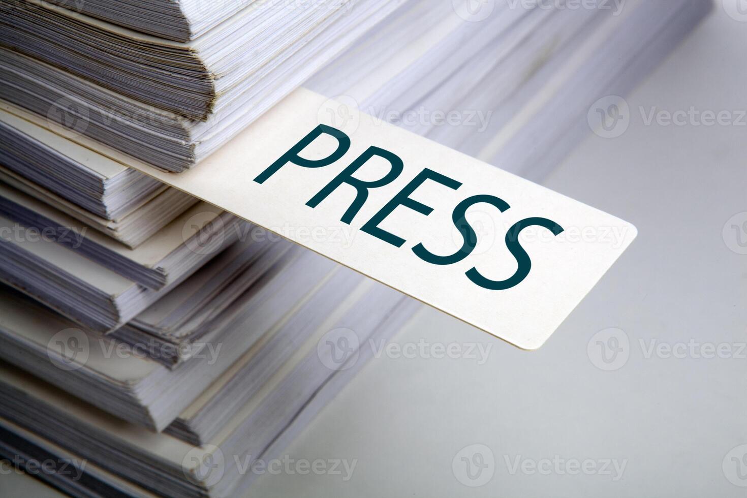 bookmark labeled press in a stack of documents concept photo