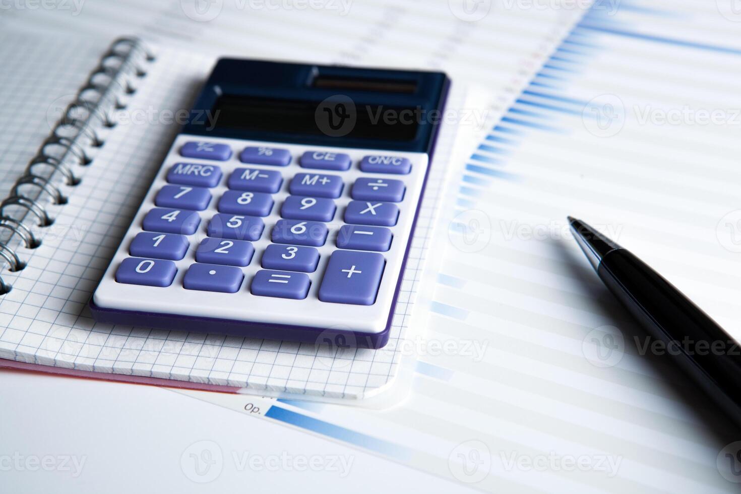 work on the calculator and papers photo