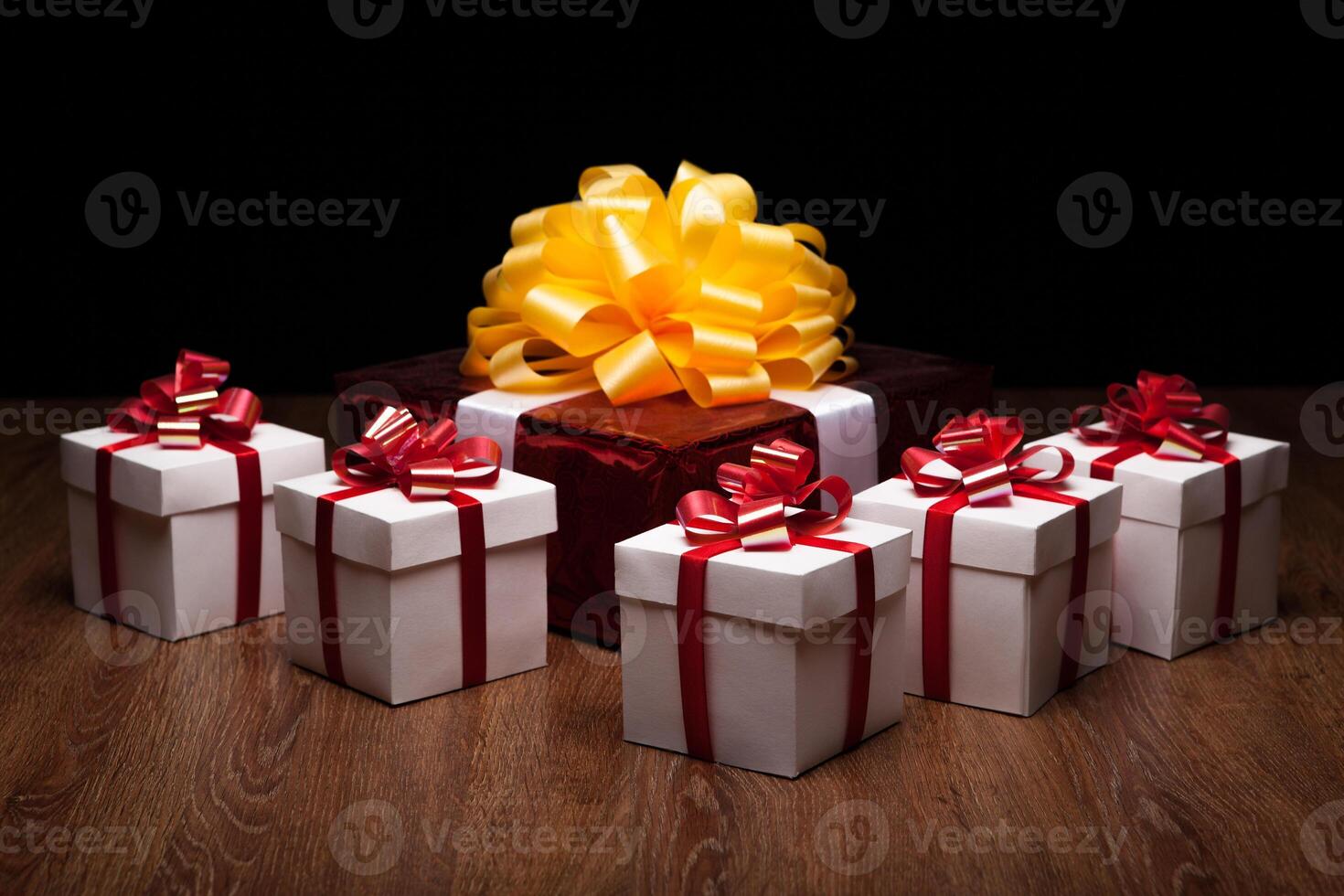 one large red gift box with small gift boxes photo