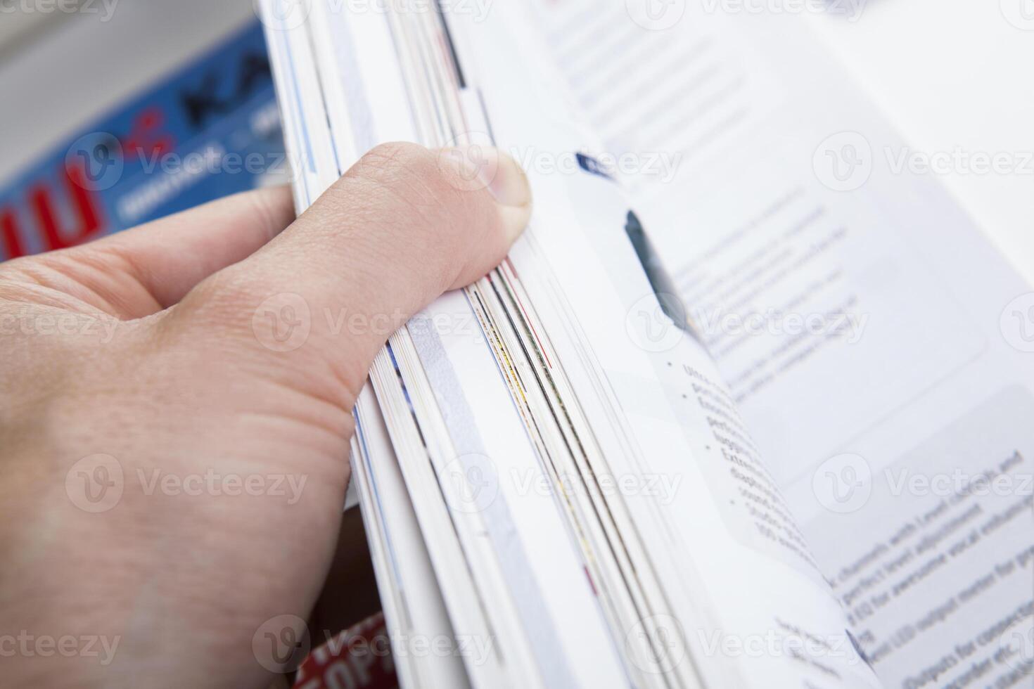 the hand through the pages of the magazine photo