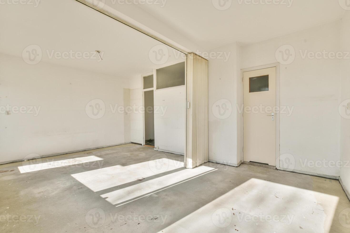 An empty room with a door and a window photo