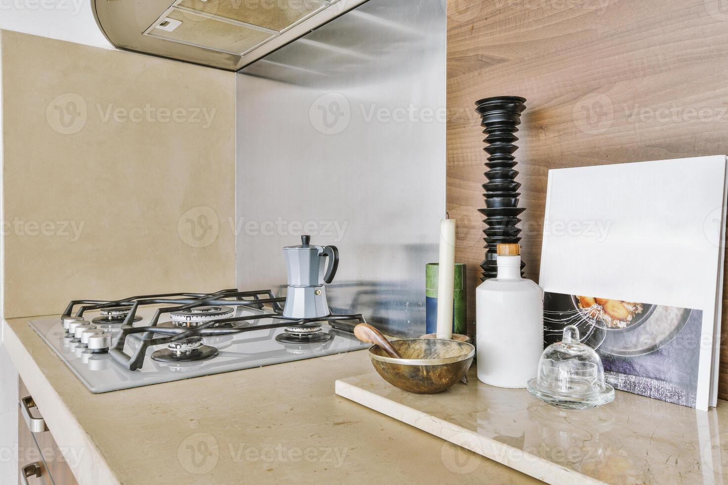 A kitchen counter with a stove top and a book on it photo