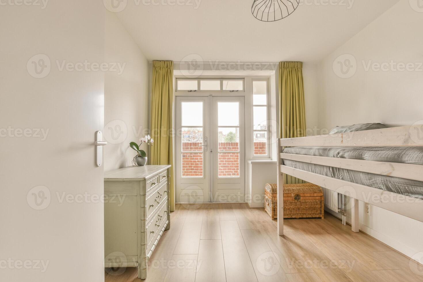 A bedroom with a bunk bed and a window photo