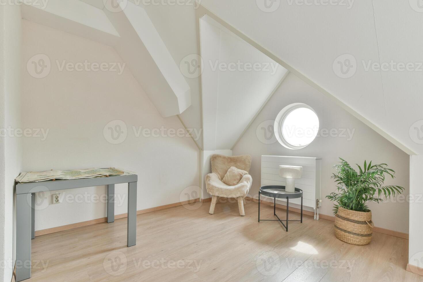 An attic room with a table and chair in it photo