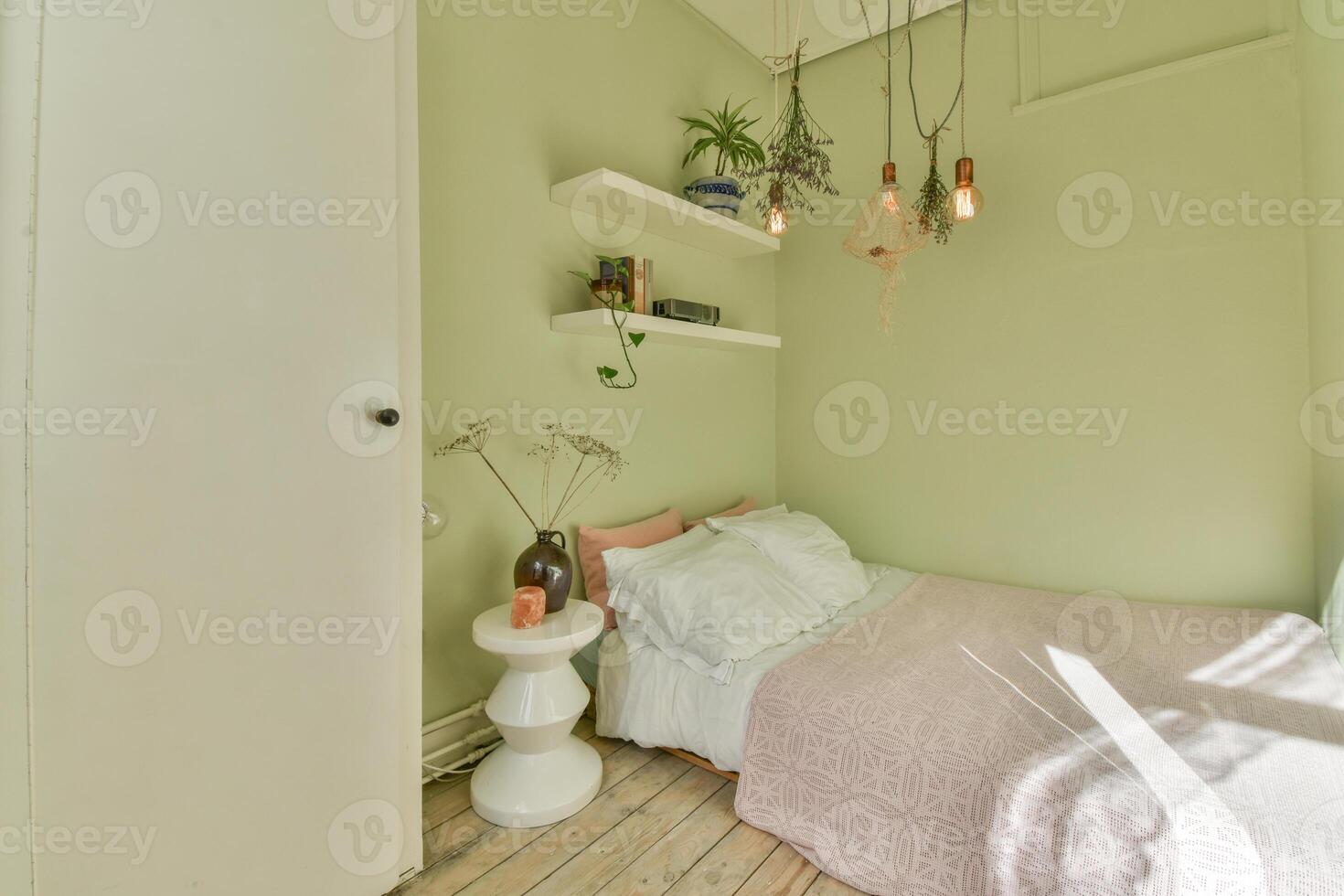 A bedroom with green walls and a bed photo